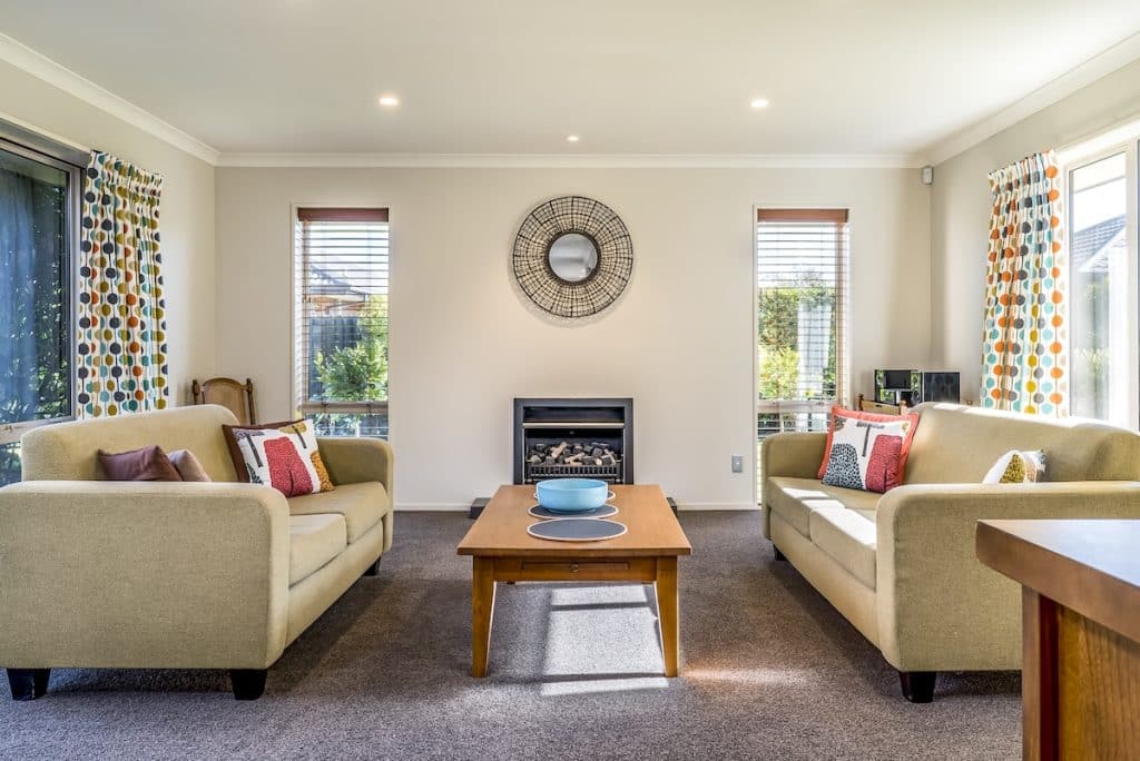 The living room of a modern apartment with two identical sofas opposite each other