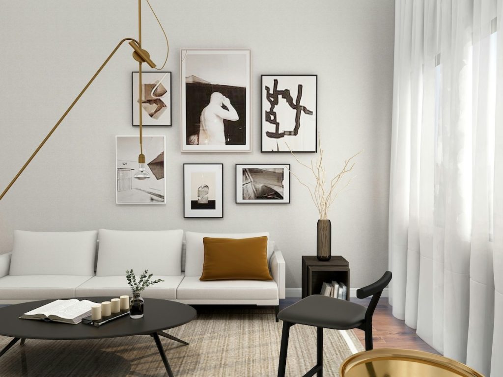 room with neutral colour pallet with artwork a sofa and chair