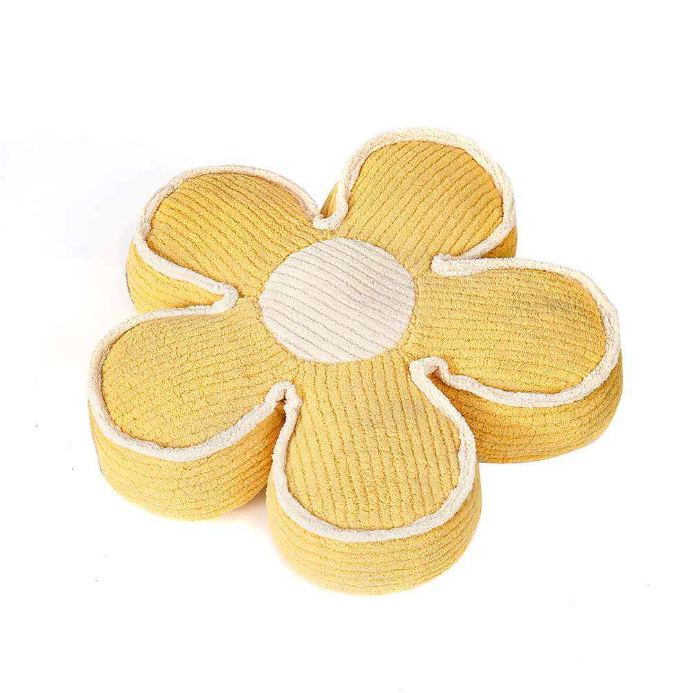 Yellow flower-shaped cushion on white background.