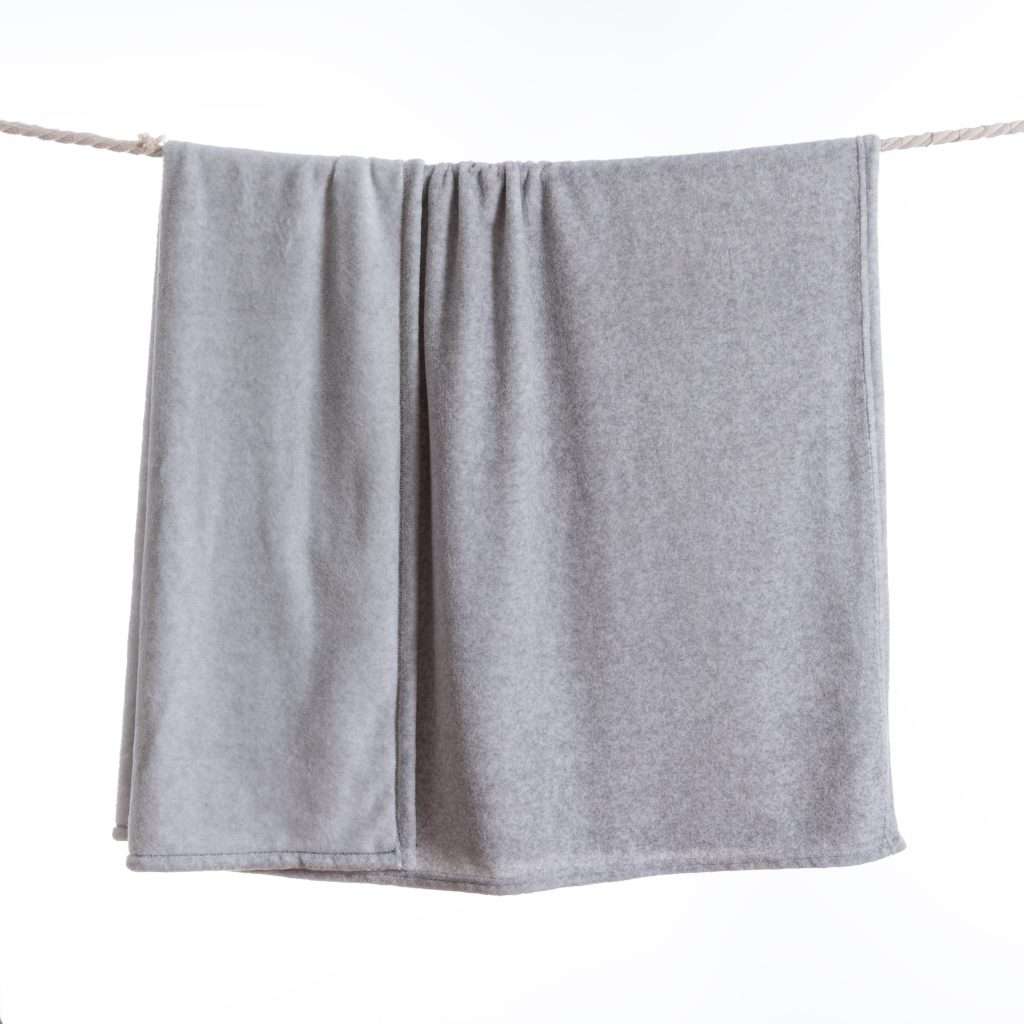 Grey blanket hanging on a rope