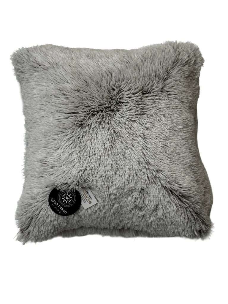 Grey furry cushion with black tag