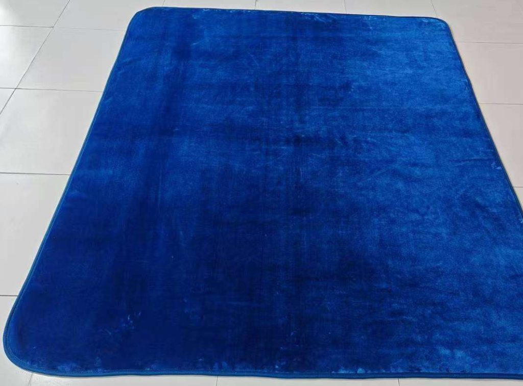 Large blue rug on tiled floor