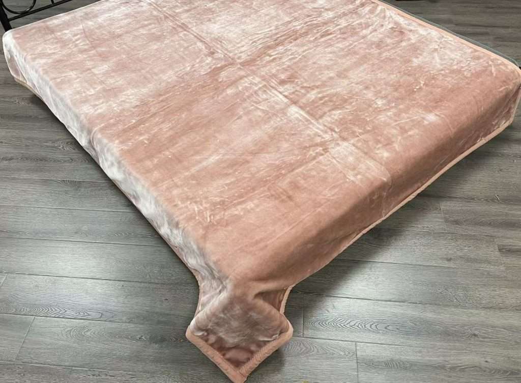 Soft pink blanket on wood floor