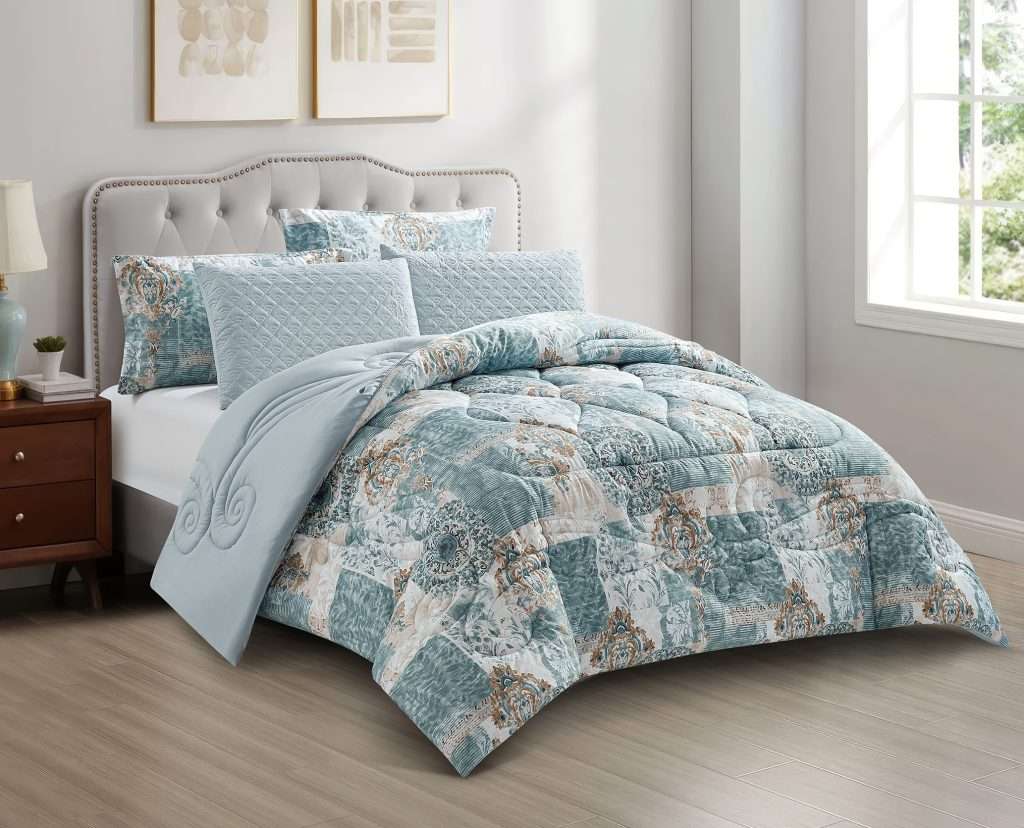 Teal patterned quilt on upholstered bed