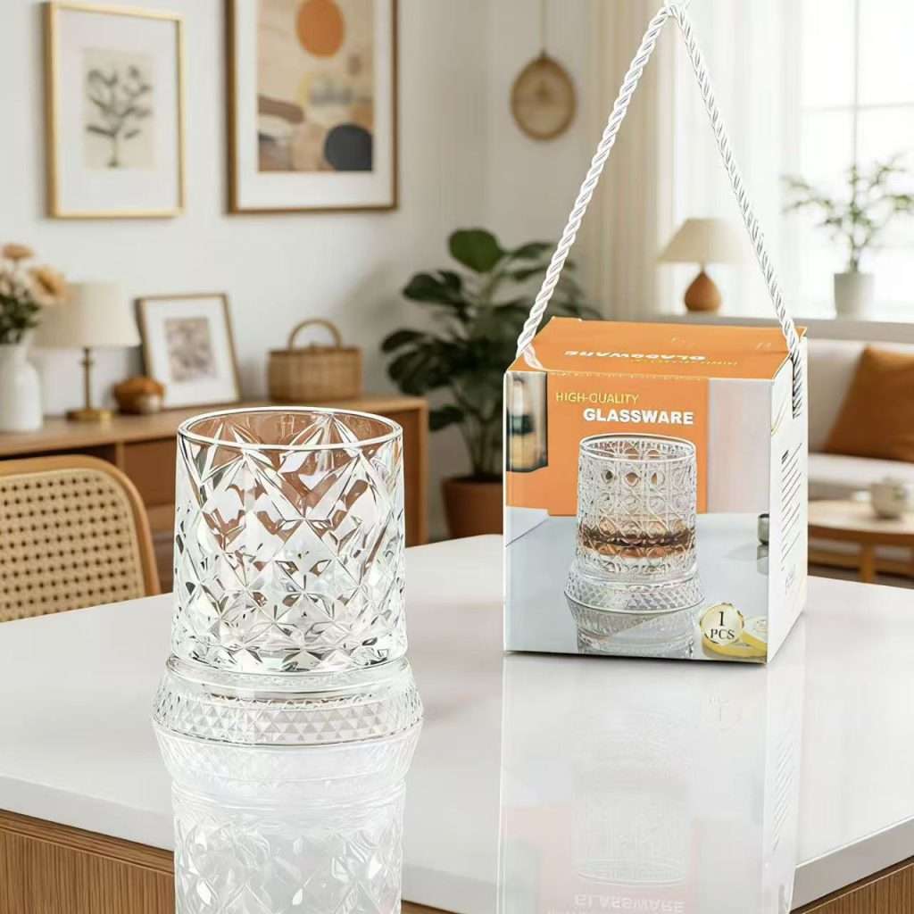 Cut-glass tumbler beside boxed high-quality glassware