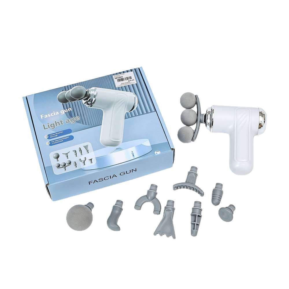 White fascia massage gun with interchangeable attachments and box